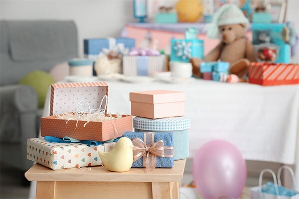 A photo of gifts on a stool for a baby shower.