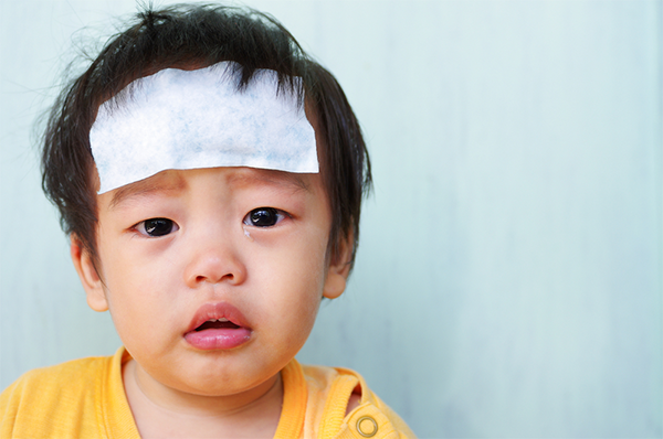 An Asian baby boy wearing a fever patch because of his fever. 