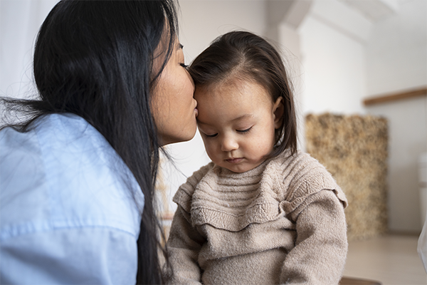 Mom talking to kid about feelings to support emotional and social development