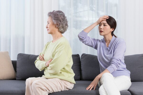 Asian women having a family conflict on the sofa.