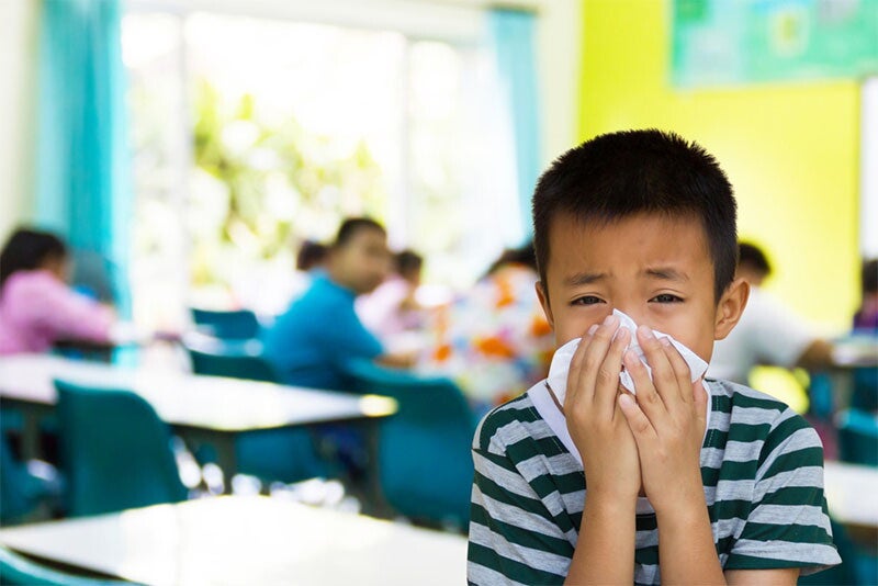Asian boy inflicted with one of the common diseases spread in a classroom