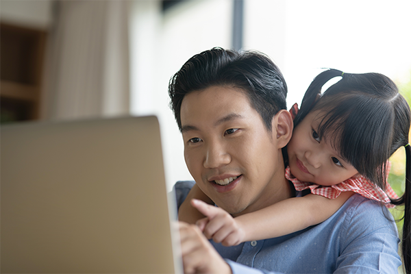Asian dad is writing down what his daughter says for a letter for Mother’s Day
