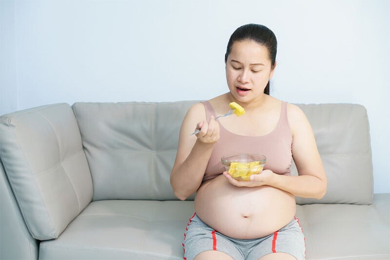 Asian female preschooler eats a slice of prebiotic-rich watermelon