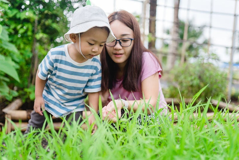 Asian mom embraces her newborn