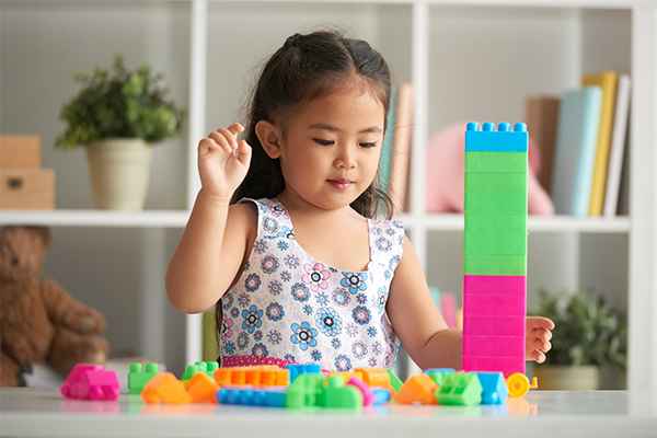 kid playing independently with blocks developing problem solving skills