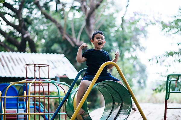 kids playing side by side at a playground learning early social skills through parallel play