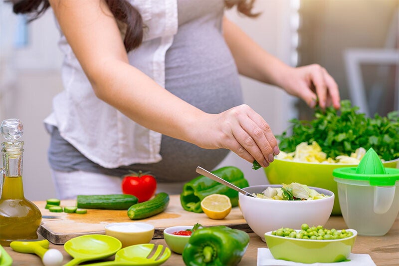 Cropped photo of a woman prepping vegetables for her healthy pregnancy meal plan.