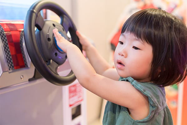 Cute Asian toddler girl playing in an indoor playground.