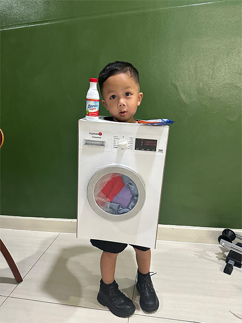 Asian boy in a washing machine costume.