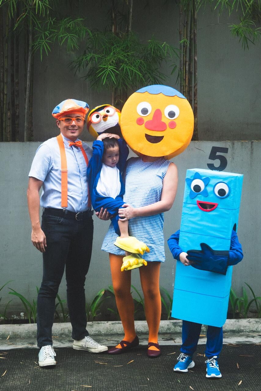 Asian family in kids’ shows characters for Halloween.
