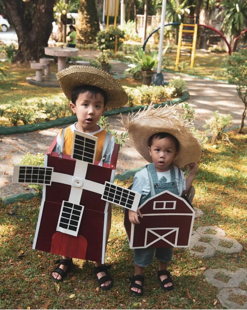 Asian boys wearing farm costumes.