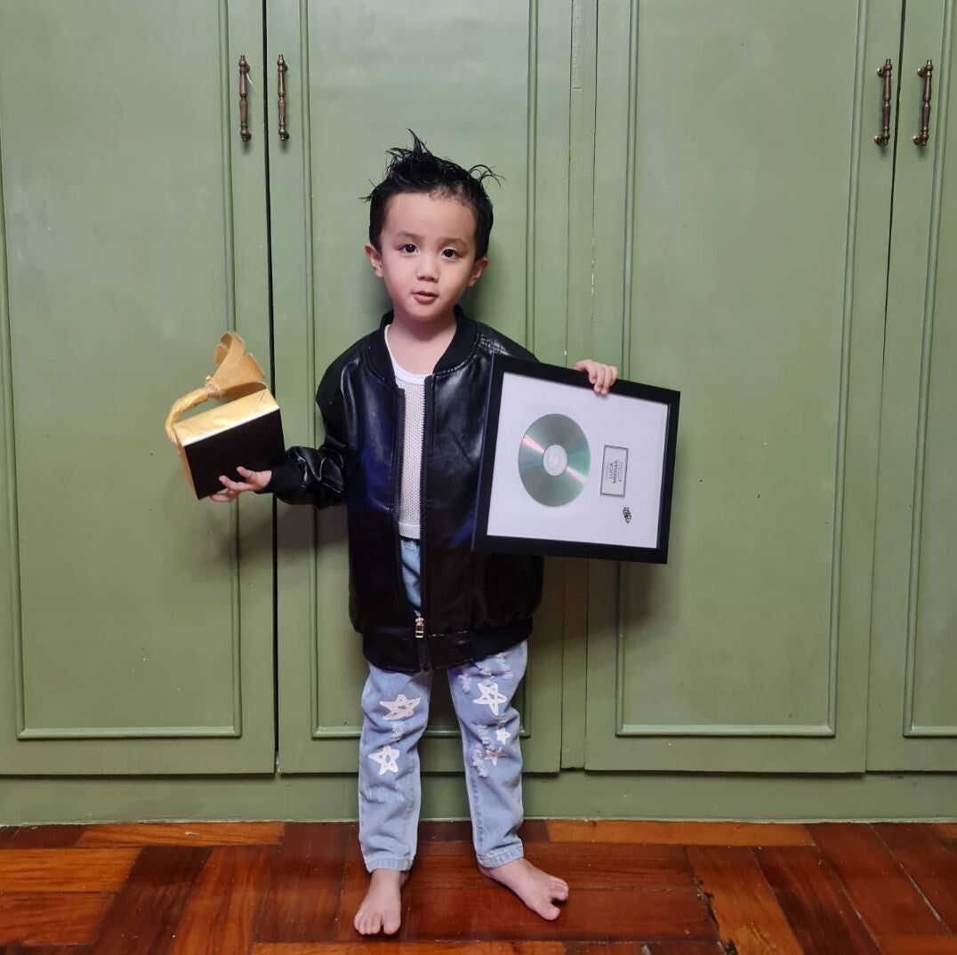 Asian boy dressed as a singer.