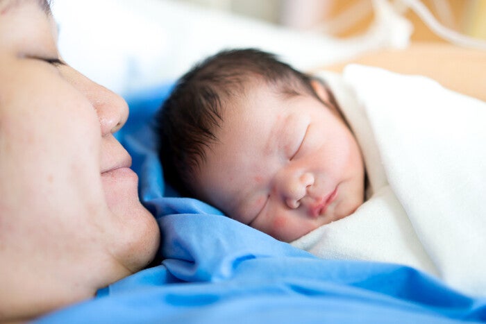 Filipino mother holds her newborn baby shortly after delivery.