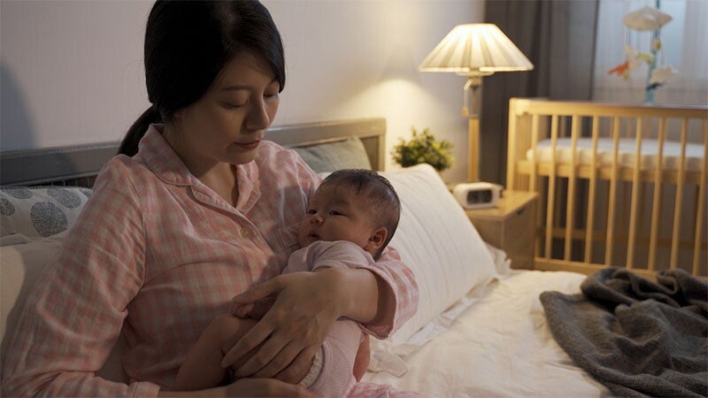 Mom carrying newborn during the evening, needing some energy-giving foods.