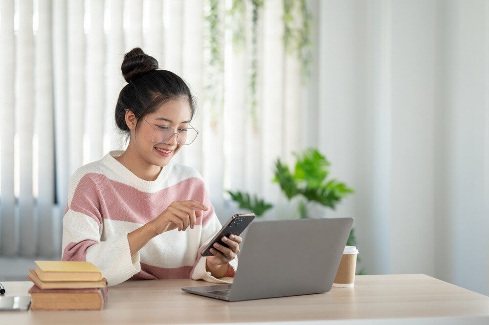 Young Asian woman checks her calendar to check if she could be pregnant.