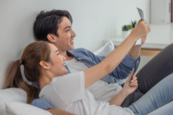 Asian couples looking at ultrasound images taken during early pregnancy.