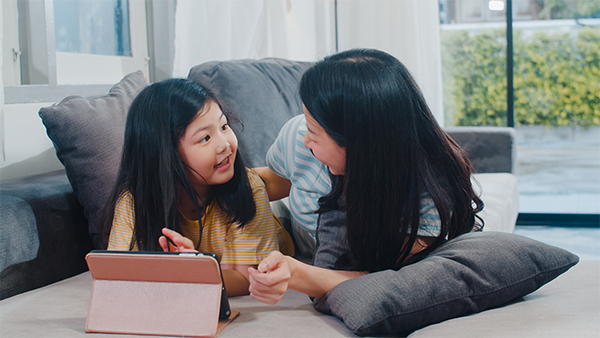 Mother and her kid conversing with each other.