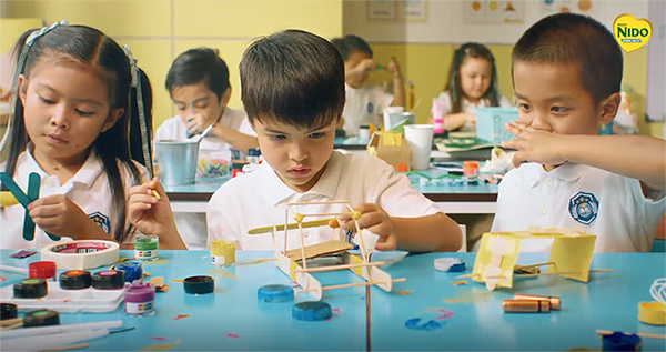 Young children in a classroom working on arts and crafts together, highlighting early learning, social interaction, and everyday exposure to germs in school environments