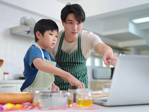 Asian dad with his kids doing arts and crafts as gift ideas for mothers