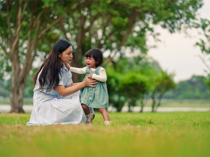Asian mom trying to console her crying toddler