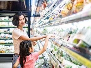 Filipino mother and daughter grocery shopping, buying vegetables for nutritious food.
