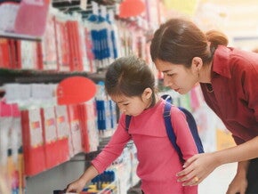 Asian mom and daughter shopping for school supplies