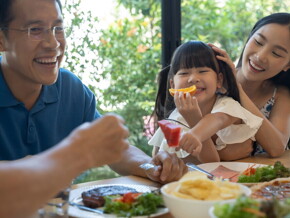 Young Asian family enjoy a meal together.