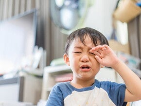 Young Asian boy crying