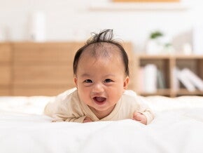 Catholic priest pours water over a baby's head for a christening or baptism ceremony. 