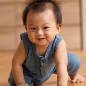 Healthy Asian baby crawl on their hands and knees on woomden floor. Healthy Asian baby crawl on their hands and knees on woomden floor.