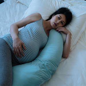 A pregnant Asian woman lying in bed awake due to insomnia during pregnancy A pregnant Asian woman lying in bed awake due to insomnia during pregnancy