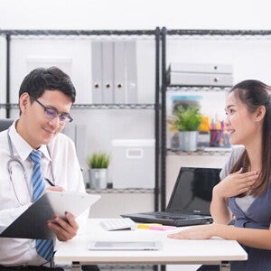 A young Asian woman talking to her doctor about her concerns regarding her high-risk pregnancy A young Asian woman talking to her doctor about her concerns regarding her high-risk pregnancy
