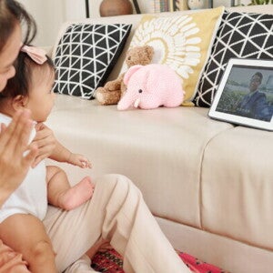 Young Asian mom on a video call with her husband to strengthen her long distance relationship.