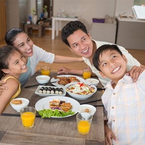 Asian boy takes a selfie with his family before they eat a meal that includes minerals in food. Asian boy takes a selfie with his family before they eat a meal that includes minerals in food.