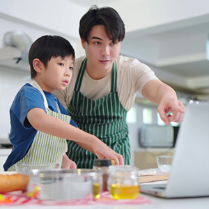Asian dad with his kids doing arts and crafts as gift ideas for mothers