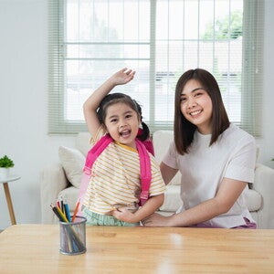 Asian mom and daughter excited to go to school Asian mom and daughter excited to go to school