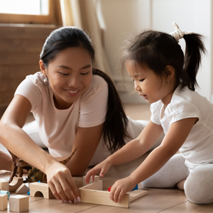 Asian mom and daughter lining up wooden blocks Asian mom and daughter lining up wooden blocks