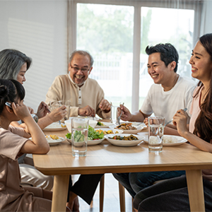 Healthy multigenerational Asian family sits down to eat a meal together Healthy multigenerational Asian family sits down to eat a meal together