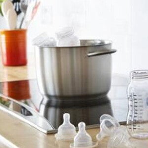 Preparing baby formula in the kitchen. Preparing baby formula in the kitchen.