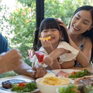 Young Asian family enjoy a meal together.