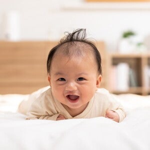 Catholic priest pours water over a baby's head for a christening or baptism ceremony. 