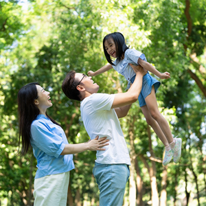 Young Asian parents models how to save money to their child by going to parks. Young Asian parents models how to save money to their child by going to parks.