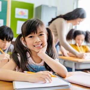 Your Asia child with notebook in classroom Your Asia child with notebook in classroom