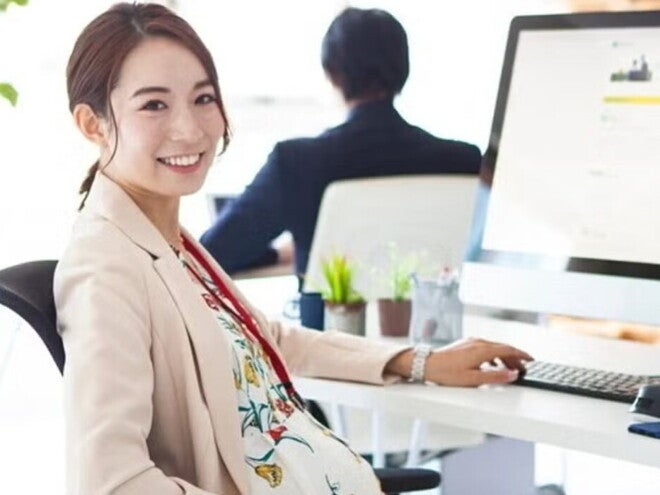 Pregnant Asian takes a break from working on her computer at an office. Pregnant Asian takes a break from working on her computer at an office.