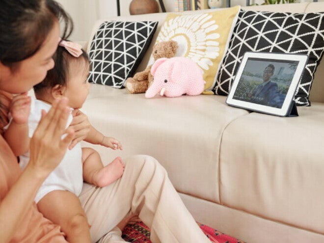 Young Asian mom on a video call with her husband to strengthen her long distance relationship.