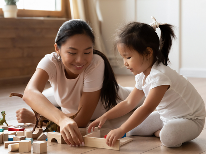 Asian mom and daughter lining up wooden blocks Asian mom and daughter lining up wooden blocks