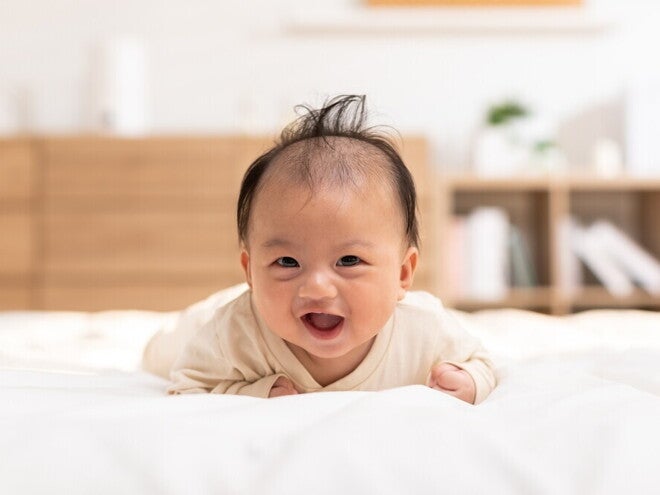 Catholic priest pours water over a baby's head for a christening or baptism ceremony. 
