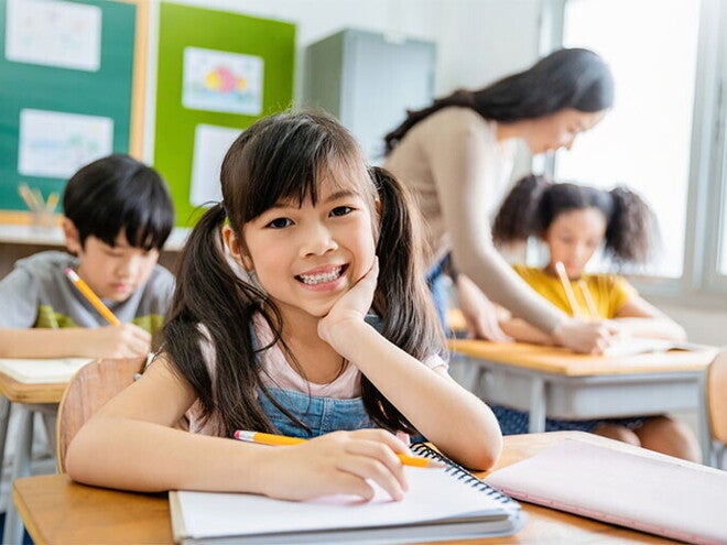 Your Asia child with notebook in classroom Your Asia child with notebook in classroom